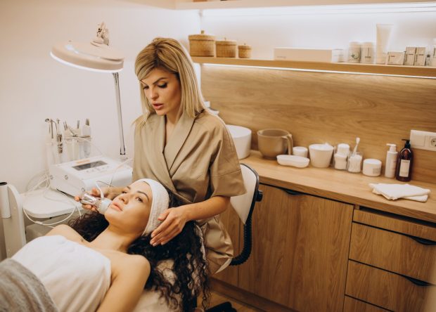 Woman at cosmetologist making beauty procedures